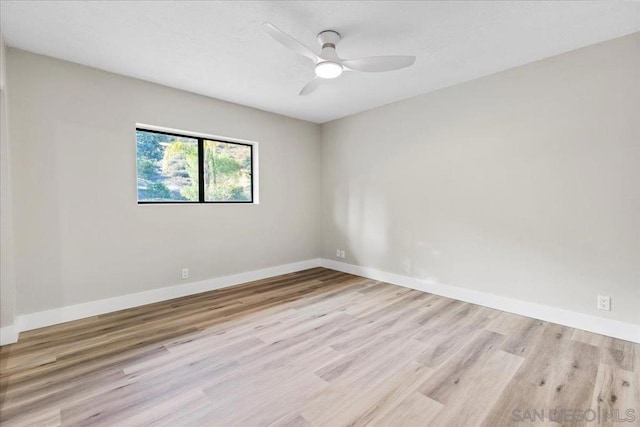 spare room with ceiling fan and light wood-type flooring