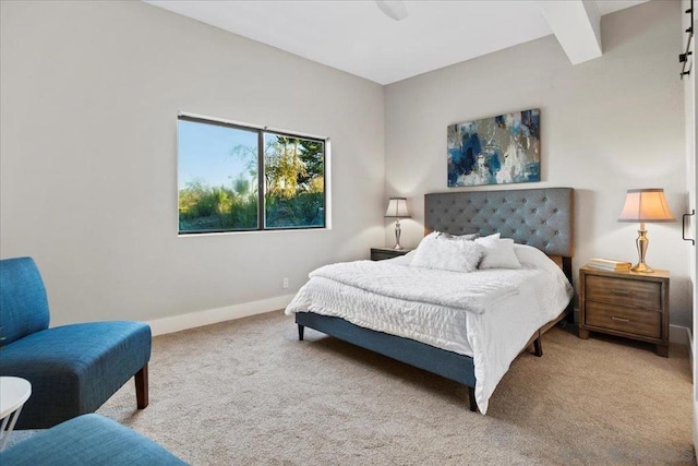 carpeted bedroom with beam ceiling