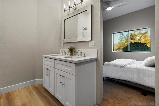 bathroom with ceiling fan, vanity, and wood-type flooring