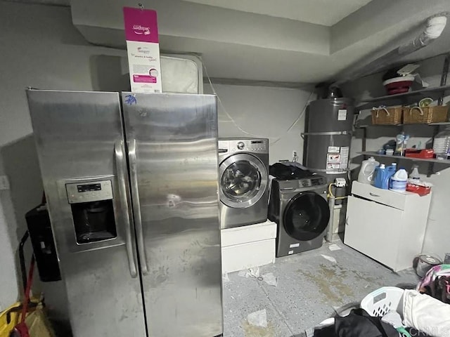 clothes washing area featuring washing machine and clothes dryer and strapped water heater