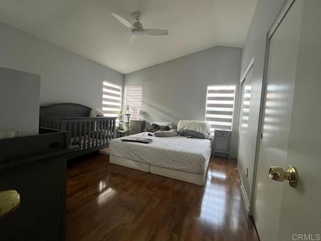 bedroom with ceiling fan, dark hardwood / wood-style flooring, and vaulted ceiling