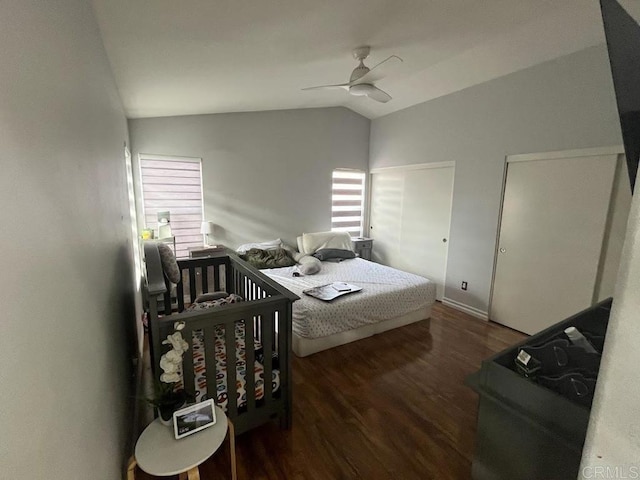 bedroom with vaulted ceiling, dark hardwood / wood-style flooring, and ceiling fan