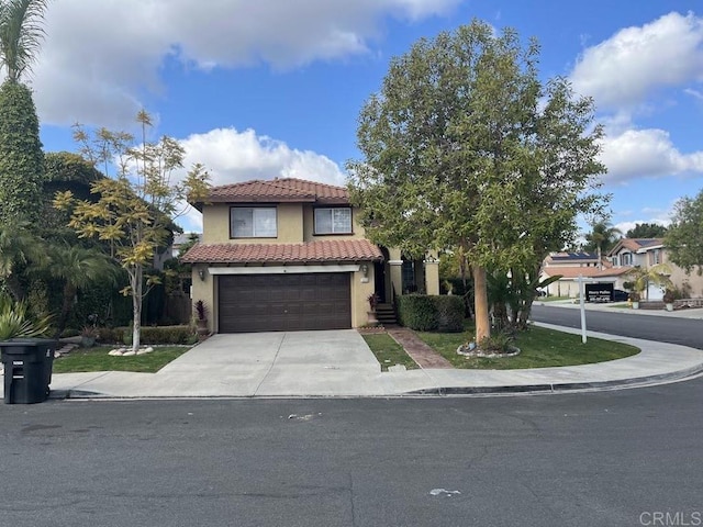 mediterranean / spanish home with a garage