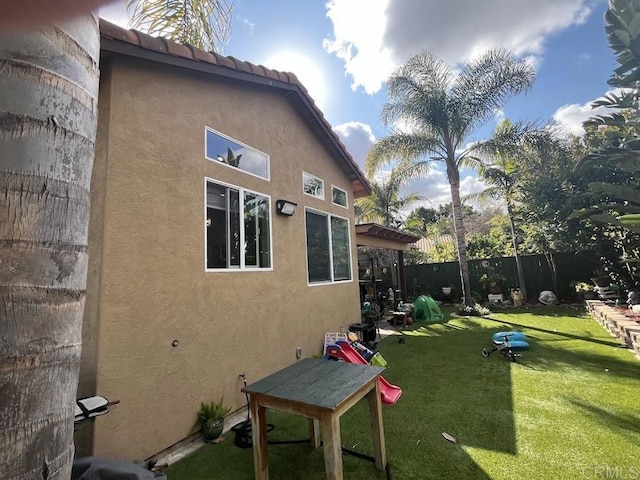 view of side of property with a lawn