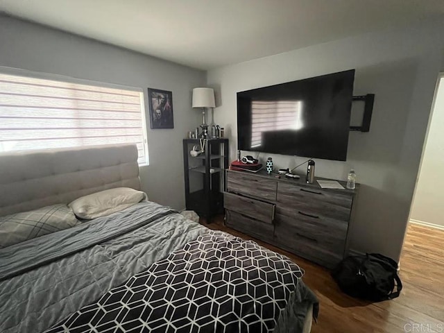 bedroom with hardwood / wood-style flooring