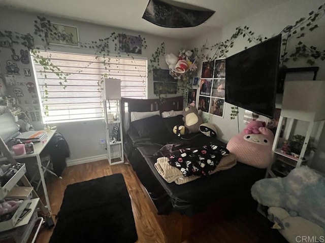 bedroom with hardwood / wood-style floors