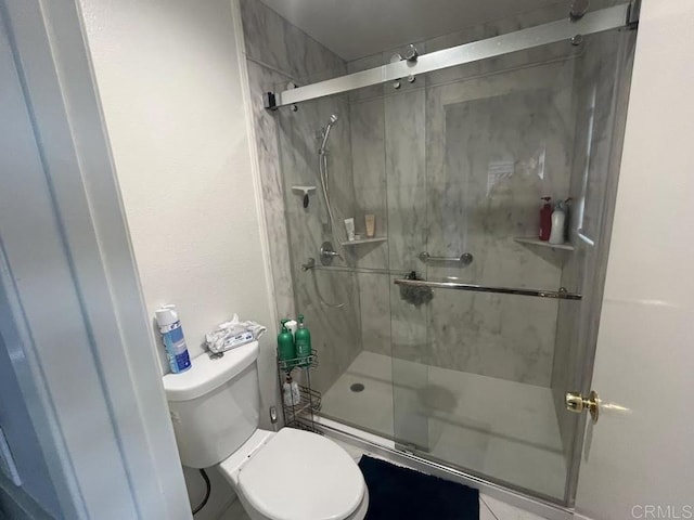 bathroom featuring toilet and an enclosed shower