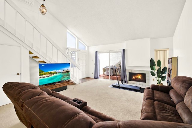 living room with light colored carpet, a fireplace, and high vaulted ceiling