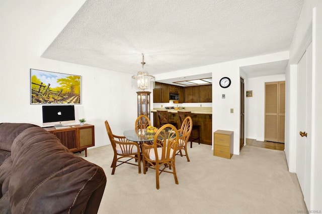 carpeted dining space with an inviting chandelier and a textured ceiling