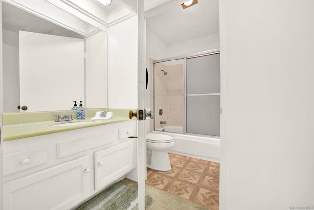 full bathroom with parquet flooring, vanity, toilet, and combined bath / shower with glass door