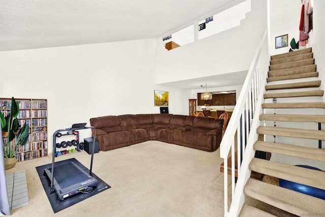 living room featuring light colored carpet and high vaulted ceiling