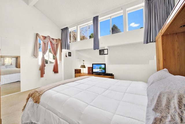 carpeted bedroom featuring high vaulted ceiling