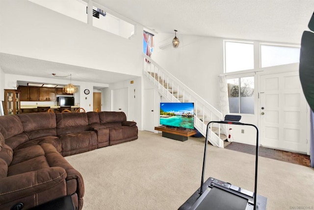 living room featuring carpet flooring and high vaulted ceiling