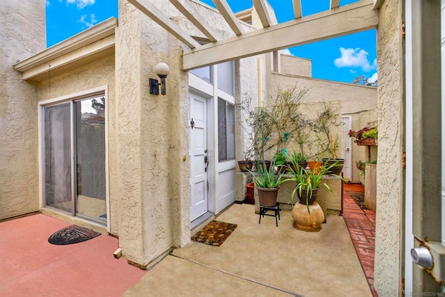 property entrance featuring a pergola