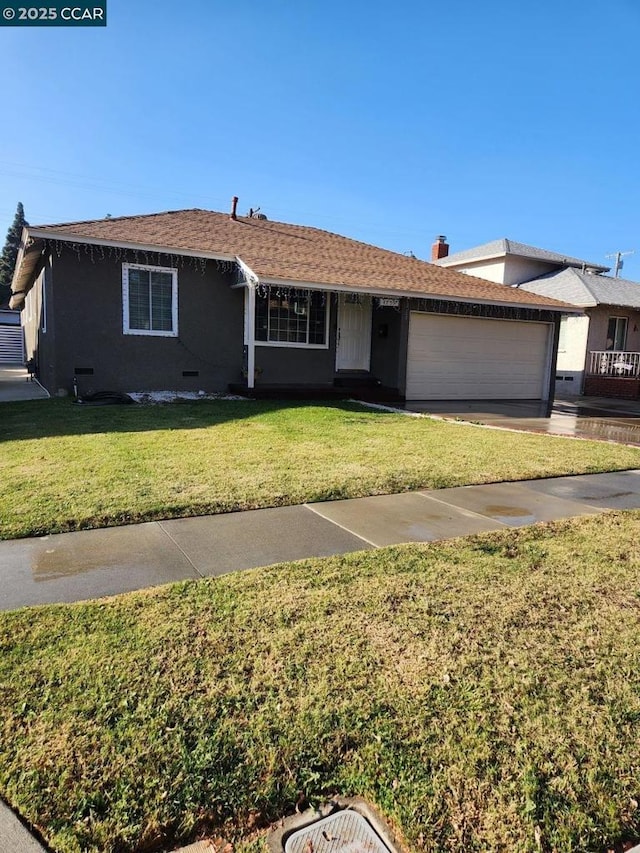 ranch-style home with a garage and a front yard