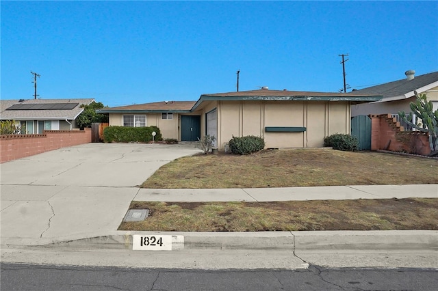 ranch-style home with a front lawn