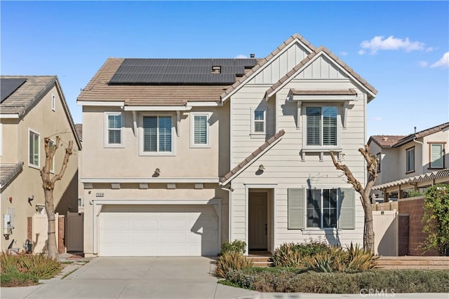 view of front of property with a garage and solar panels