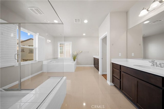 bathroom with vanity, a washtub, and tile patterned floors