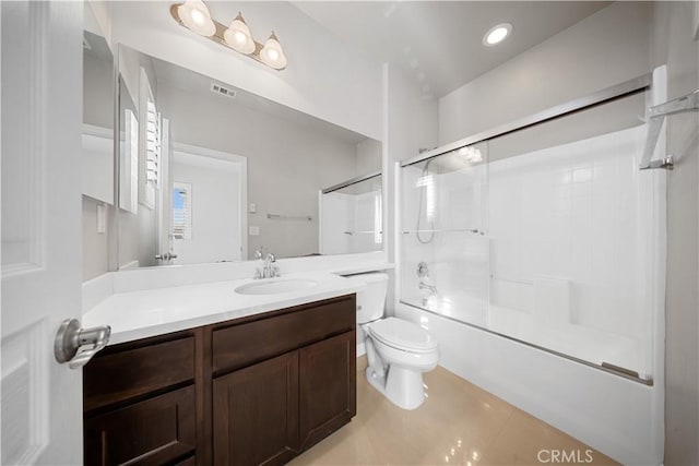 full bathroom featuring vanity, tile patterned floors, enclosed tub / shower combo, and toilet