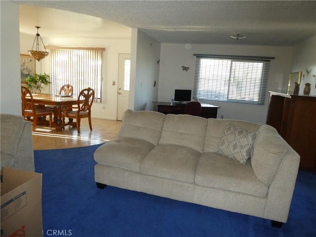 tiled living room with a textured ceiling