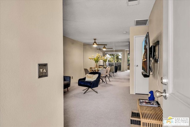 interior space featuring carpet floors and a textured ceiling