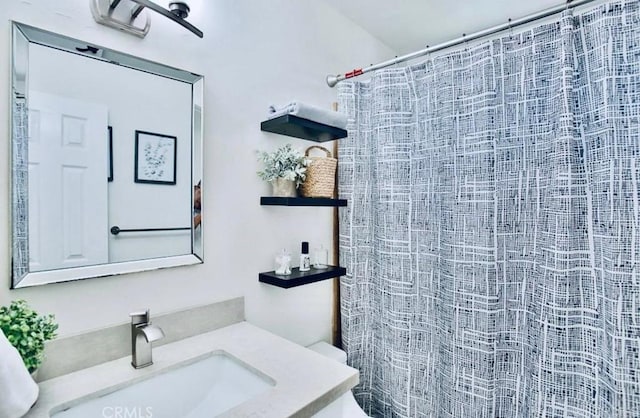 bathroom featuring vanity and curtained shower