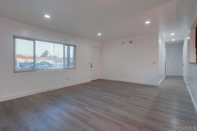 spare room with wood-type flooring