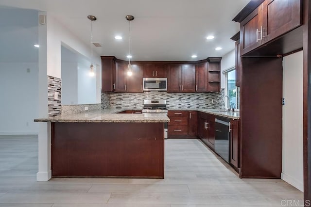 kitchen with a sink, light stone countertops, stainless steel appliances, and decorative backsplash