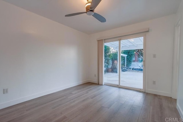 spare room with a ceiling fan, baseboards, and wood finished floors