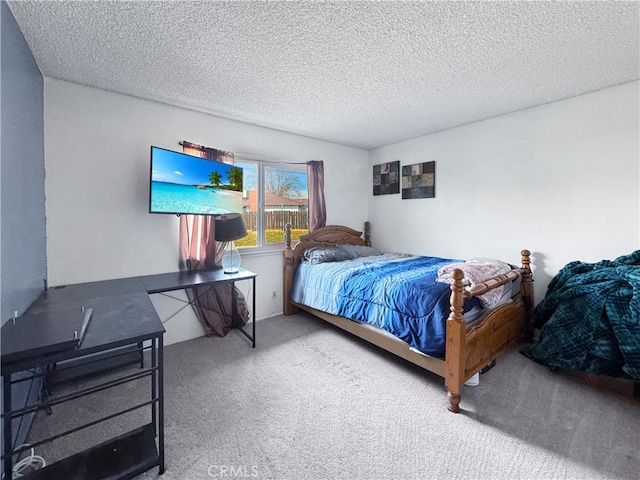 bedroom featuring carpet floors and a textured ceiling