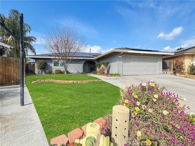 ranch-style home featuring a garage, a front lawn, and solar panels