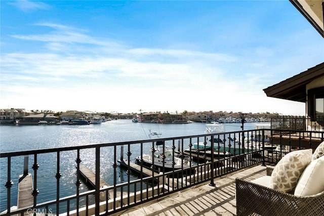 dock area featuring a balcony and a water view