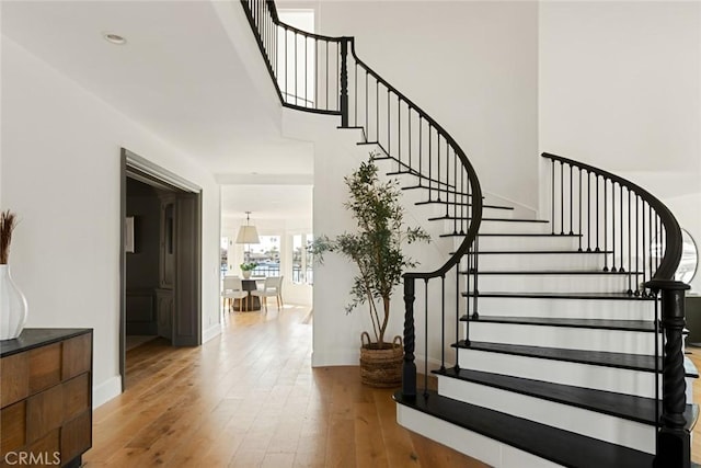 stairs with hardwood / wood-style floors