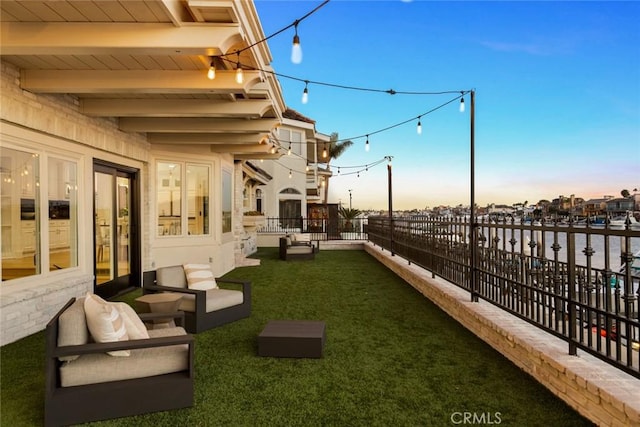 yard at dusk featuring outdoor lounge area