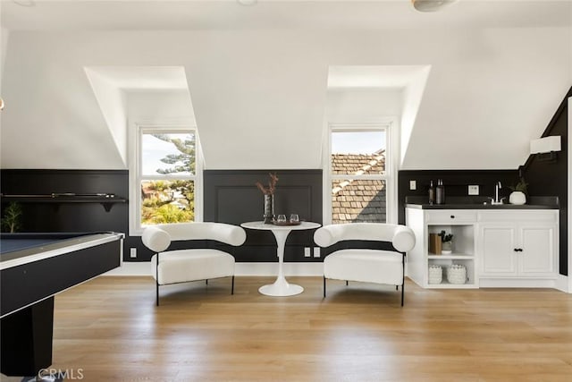 sitting room featuring a healthy amount of sunlight, sink, and light hardwood / wood-style flooring