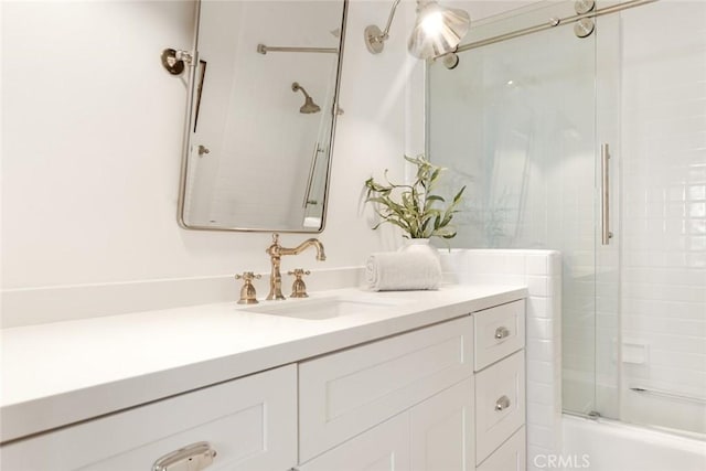 bathroom with vanity and combined bath / shower with glass door