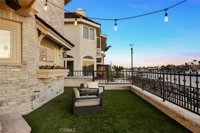 yard at dusk featuring outdoor lounge area