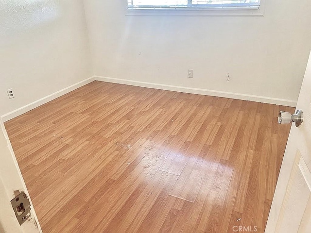 unfurnished room with wood-type flooring