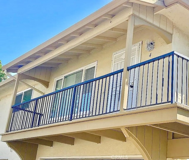 view of side of home featuring a balcony