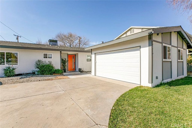 ranch-style home featuring a garage and a front yard