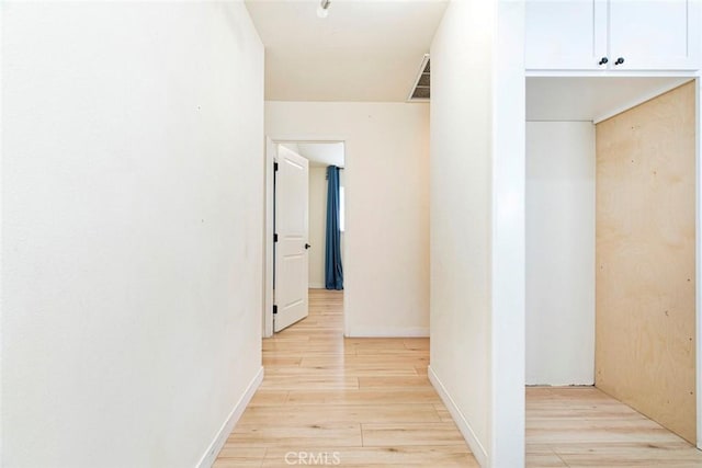 corridor with light wood-type flooring