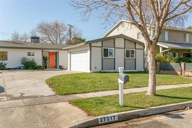 view of front of house with a garage and a front lawn