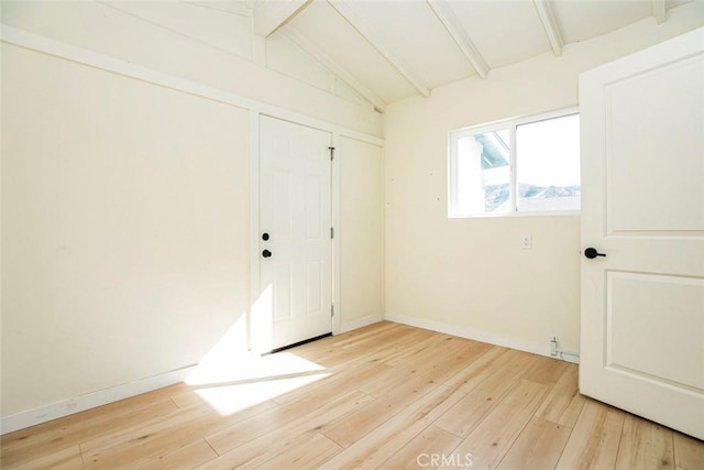 interior space featuring lofted ceiling with beams and light wood-type flooring