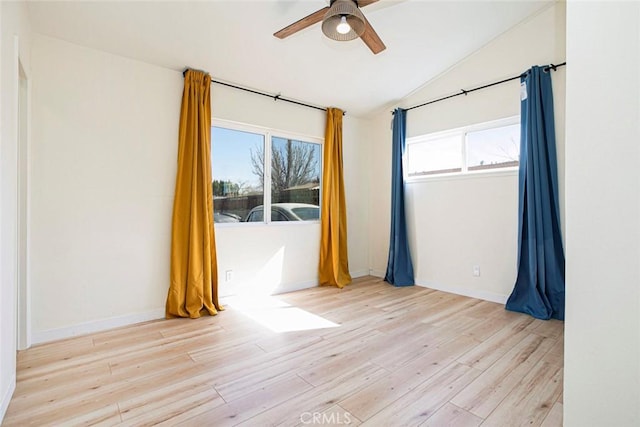 spare room featuring ceiling fan, lofted ceiling, and light hardwood / wood-style floors