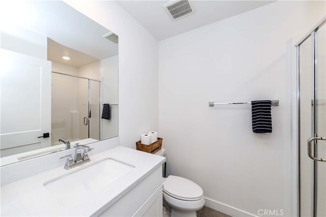 bathroom with vanity, toilet, and walk in shower