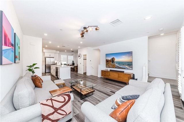 living room with sink and hardwood / wood-style flooring