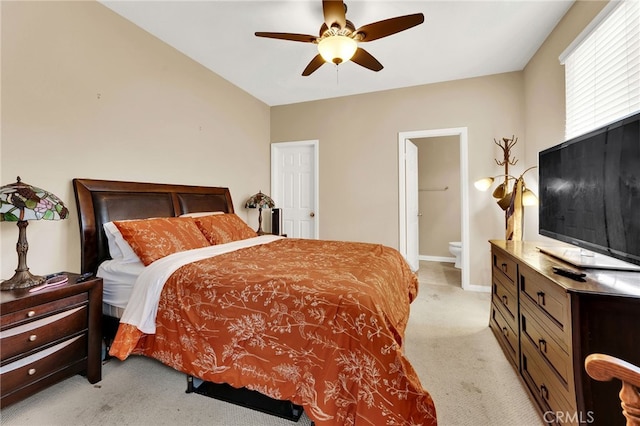 carpeted bedroom featuring ceiling fan and ensuite bathroom