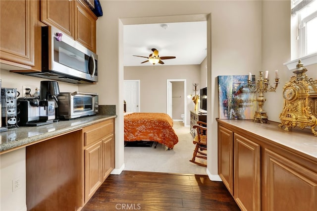 kitchen with dark hardwood / wood-style floors and ceiling fan