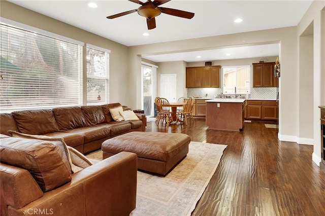 living room featuring sink, dark hardwood / wood-style floors, and ceiling fan