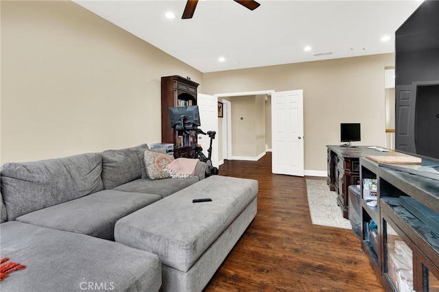 living room featuring ceiling fan and dark hardwood / wood-style floors